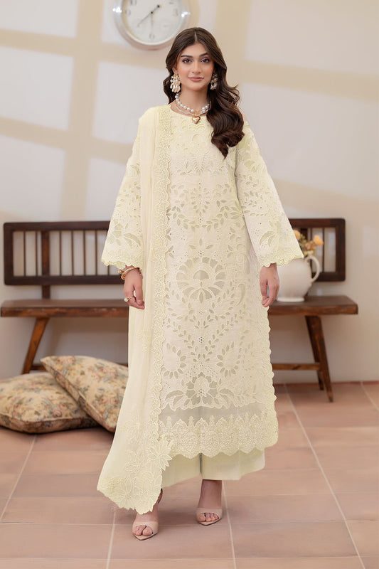 Woman wearing a cream embroidered outfit in an indoor setting