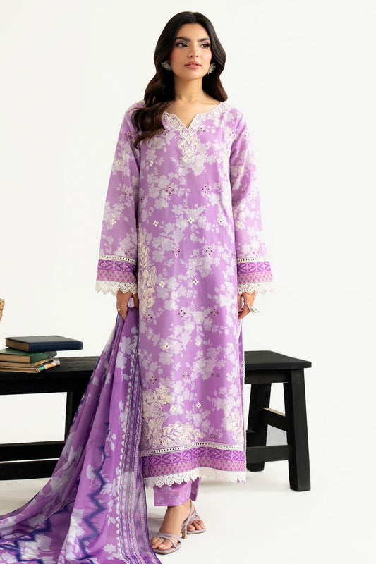 Woman wearing a purple floral dress with a matching dupatta on a white background