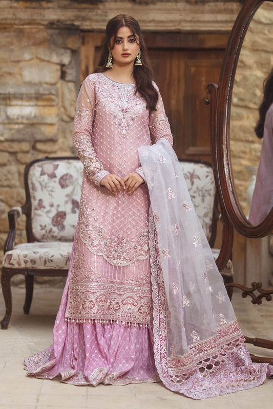A woman wearing a pink and white embroidered organza front and back with dupatta, sleeves, and an embroidered organza border. The outfit includes a raw silk sharara and zari lamba lining.