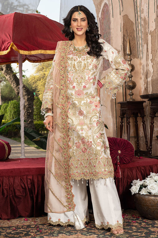 Woman in traditional embroidered outfit standing in an ornate indoor setting.