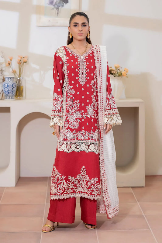 Woman wearing a red embroidered traditional outfit in an indoor setting.